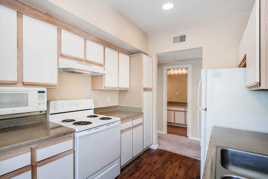 a kitchen with white appliances and white cabinets