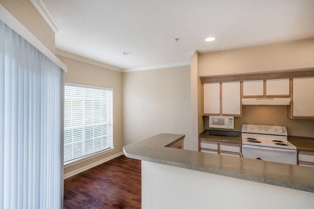 a kitchen with a large window and a counter top