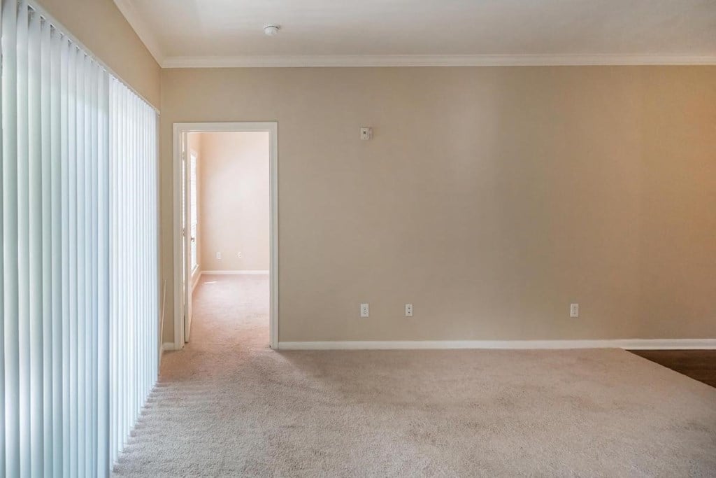 a empty living room with a sliding glass door