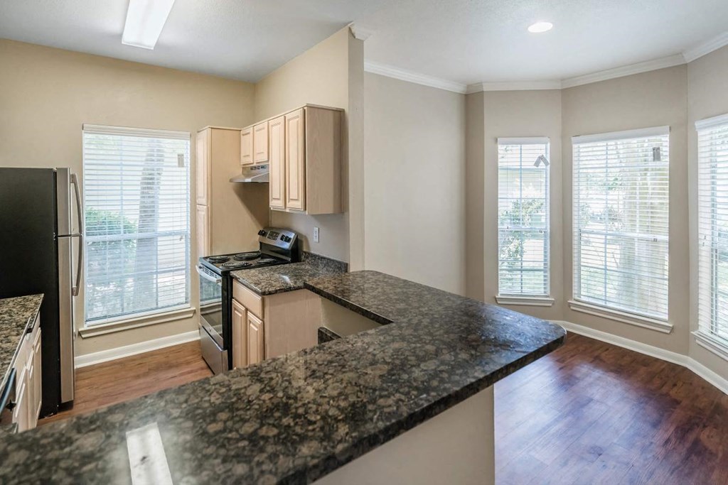 an empty kitchen with a counter top in the middle