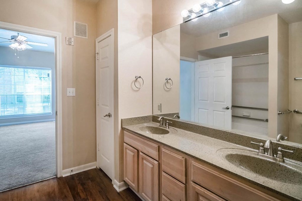 a bathroom with two sinks and a large mirror