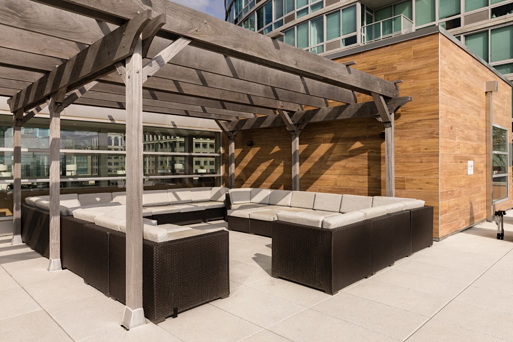 an outdoor patio with tables and a pergola