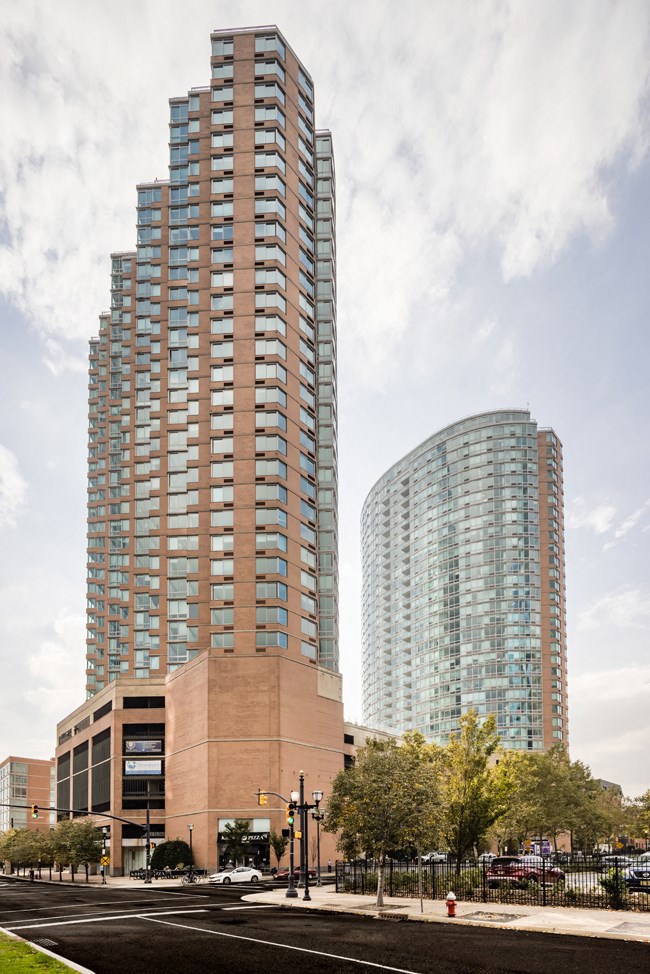 a view of two tall buildings on a city street