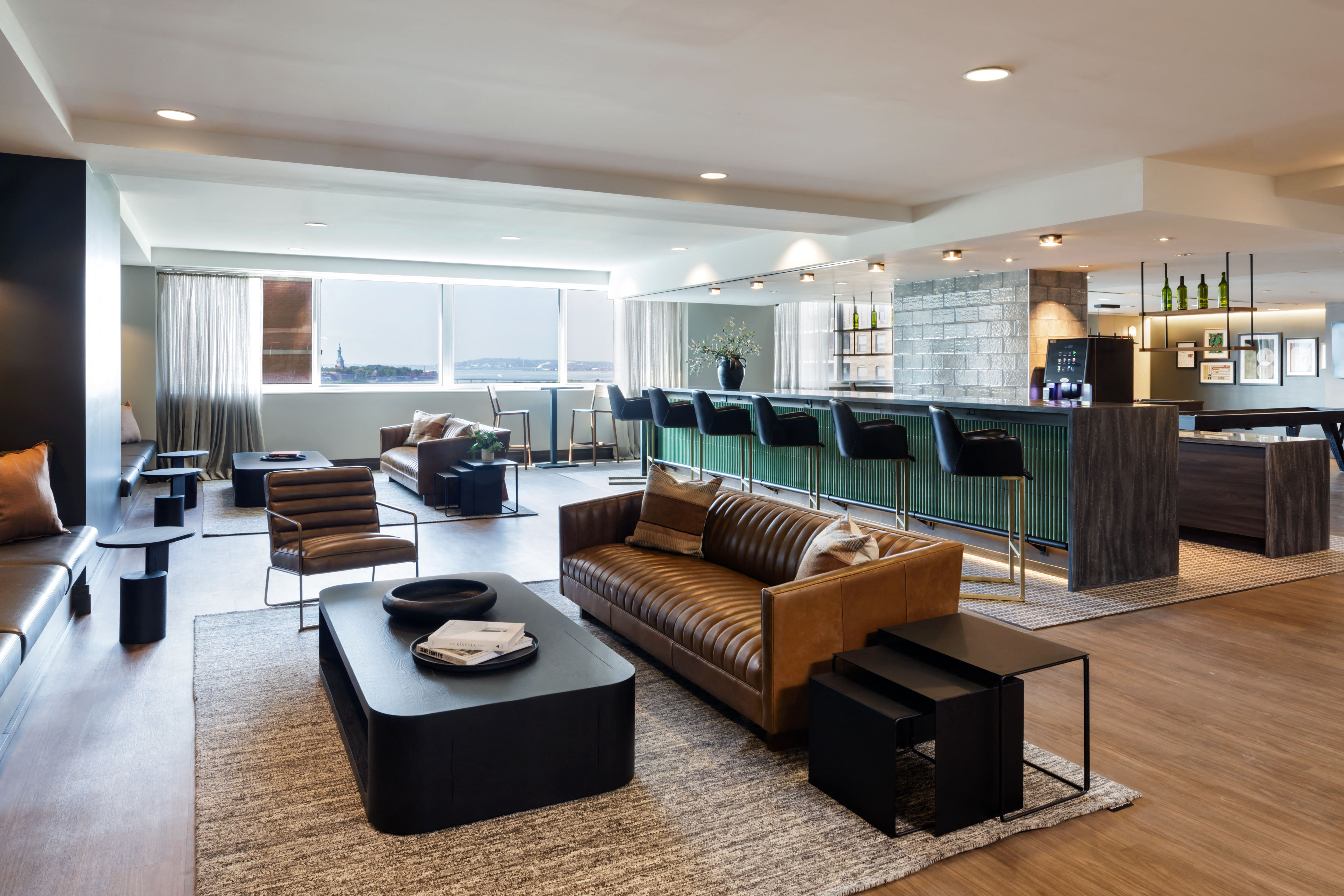 a large living room with leather furniture and a bar