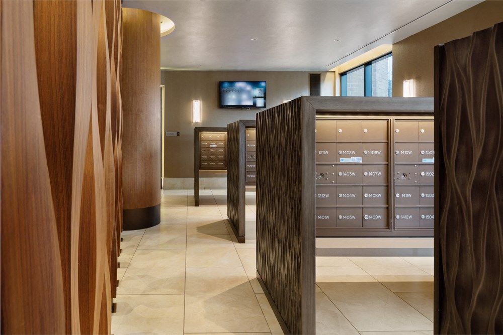 a view of a locker room with a bank of cabinets and a television in the