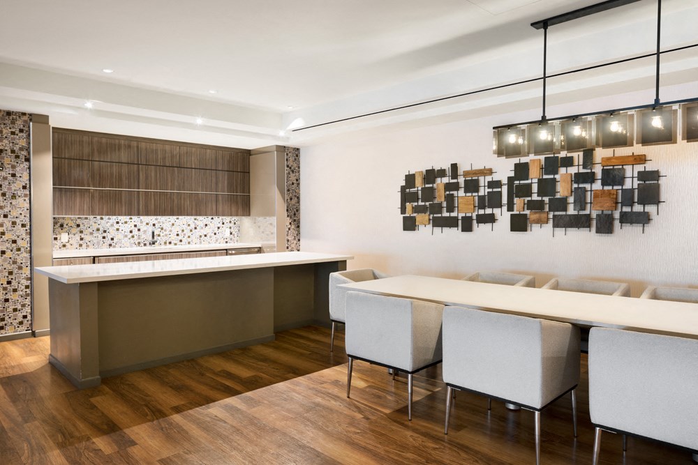 a rendering of a kitchen and dining room with a bar and chairs