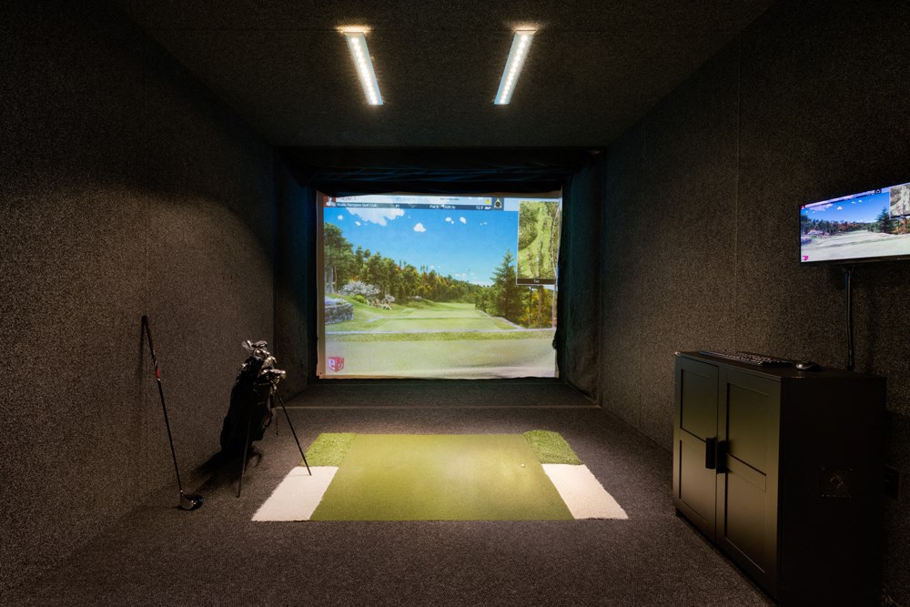 a dog standing in a room with a view of a golf course