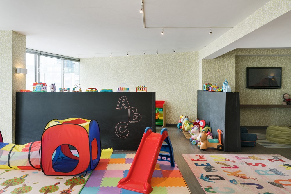 a playroom with a chalkboard wall and a childs room with a bed