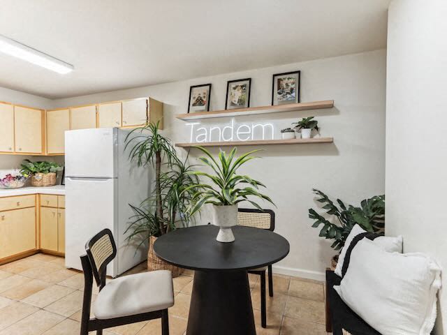 A dining area with a table and chairs.