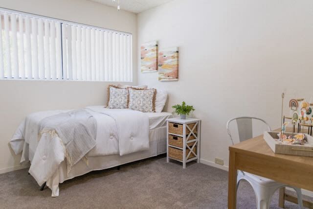 a bedroom with a bed and a table