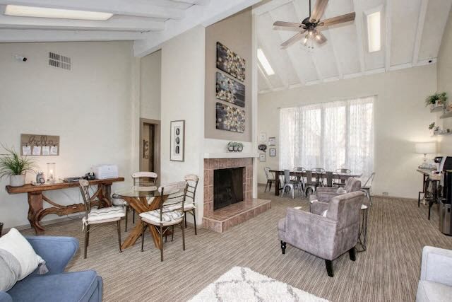 a living room with a fireplace and a table and chairs