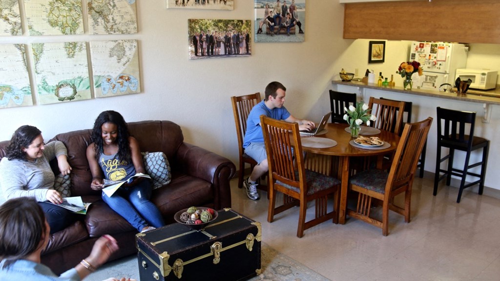 a group of people sitting on a couch in a living room