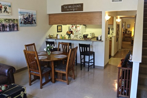 a dining room and kitchen with a table and chairs