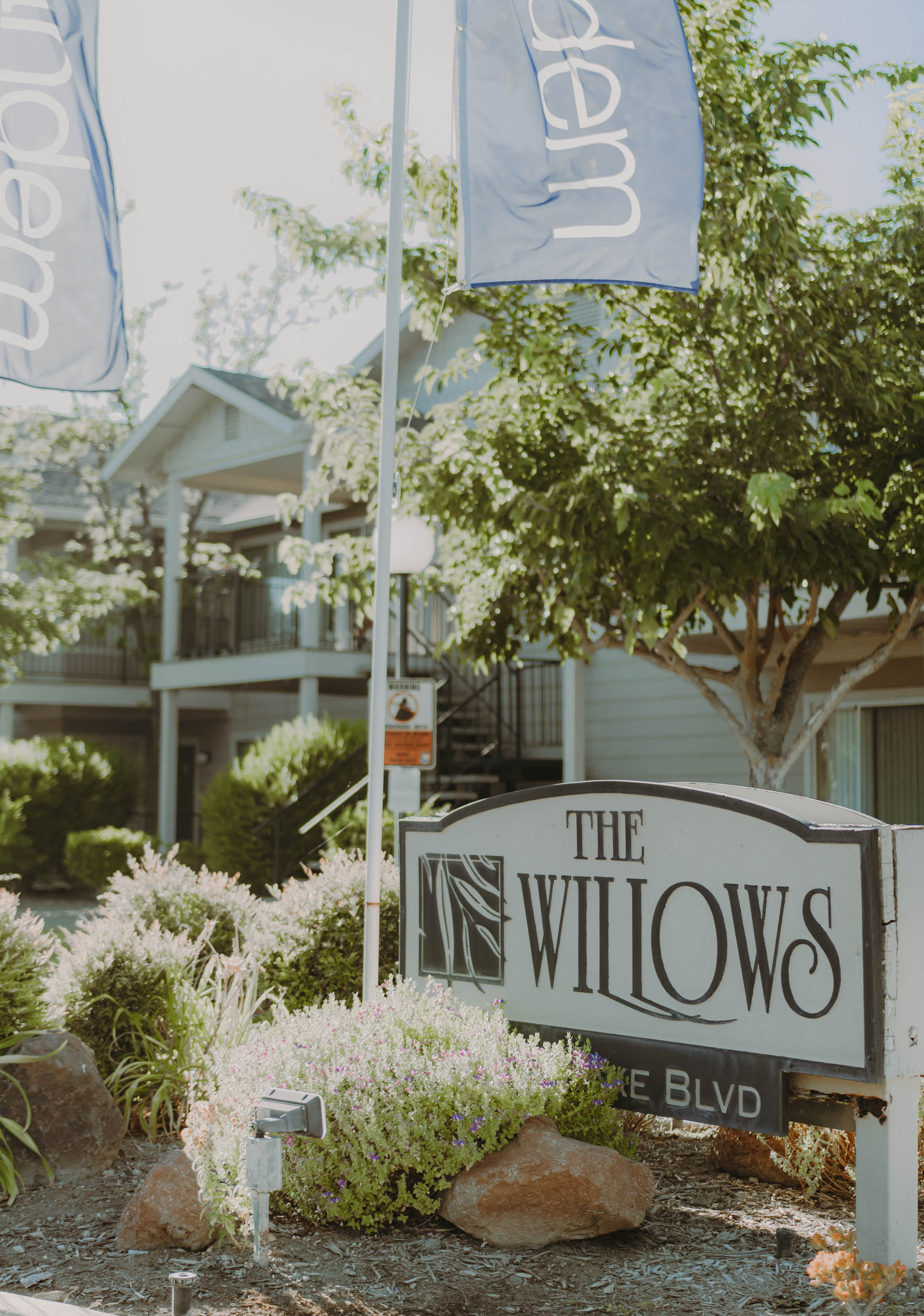 a sign for the willows in front of a house