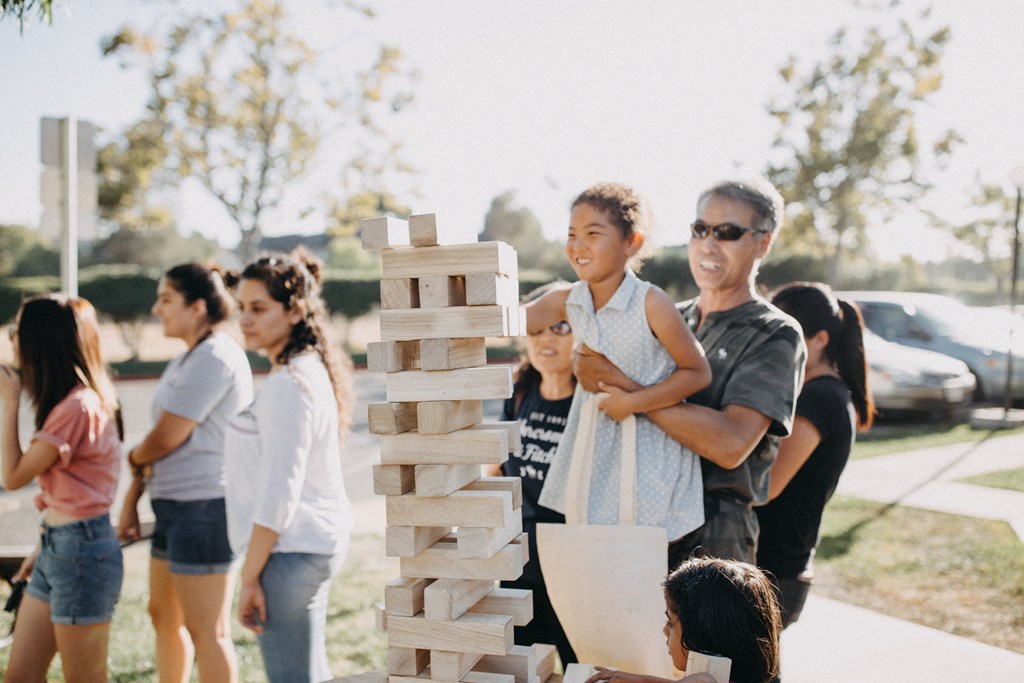 a group of people playing a game of jenga