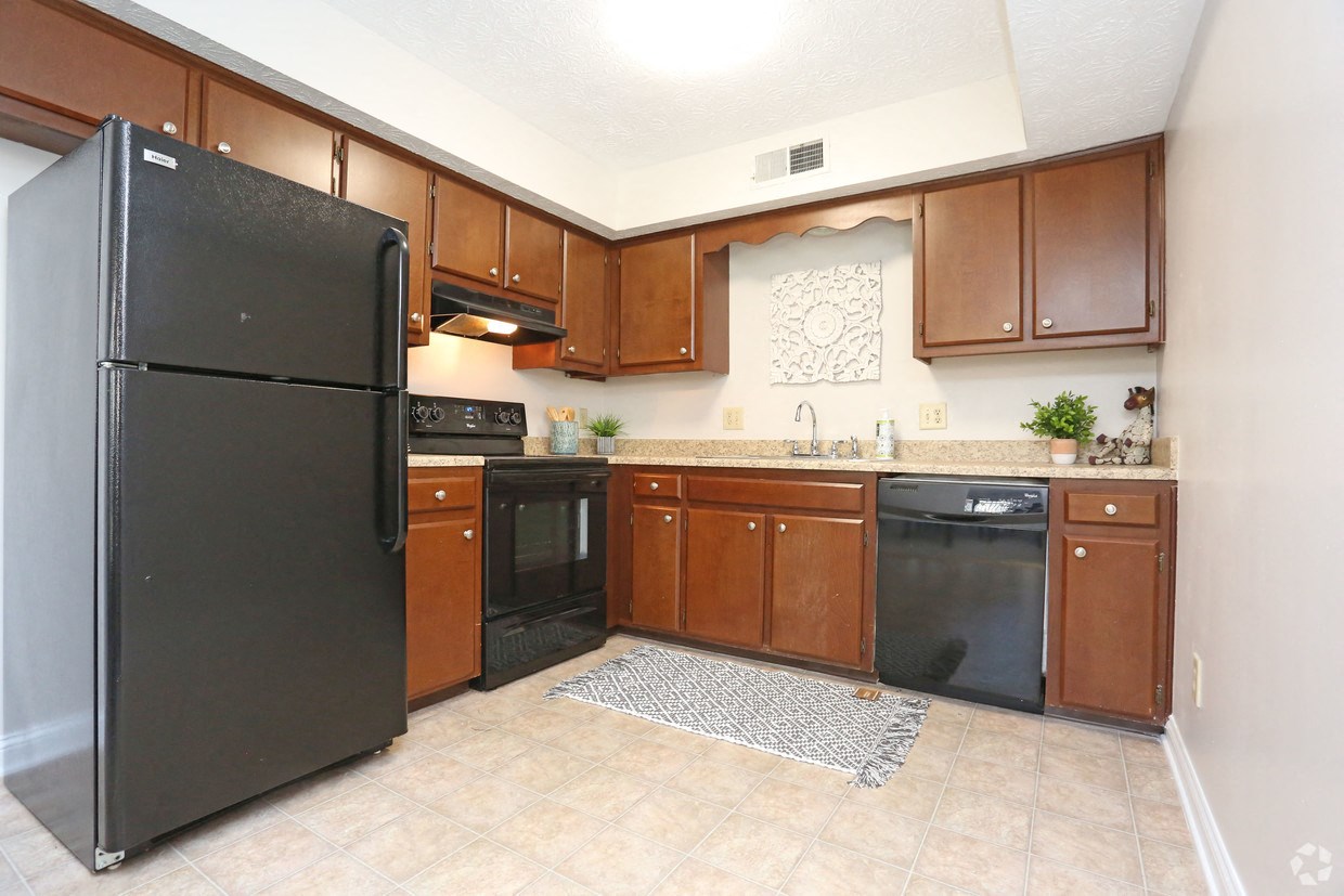 a kitchen with black appliances and wooden cabinets