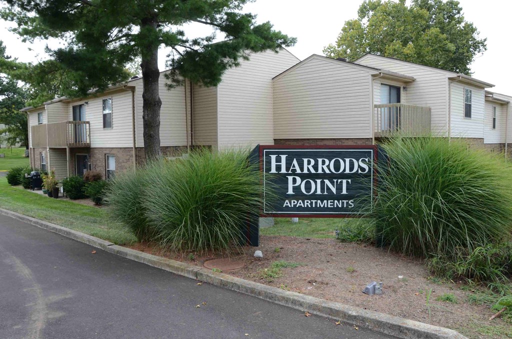 an apartment building with a harbor point apartments sign in front