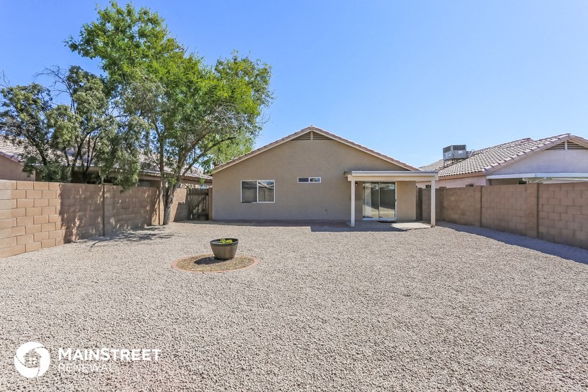 a home with a gravel driveway and a garage
