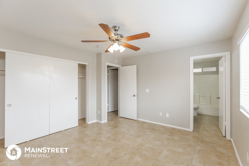 the master bedroom has a large closet and a ceiling fan