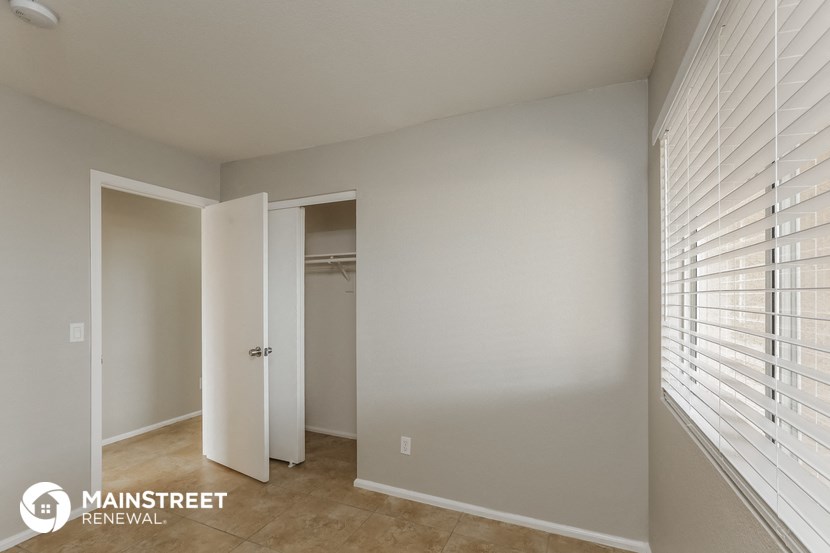 a bedroom with a closet and a door to a closet