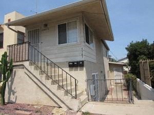 A house with a staircase leading to the front door.