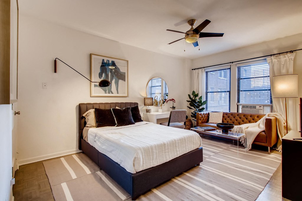 a bedroom with a bed and a ceiling fan