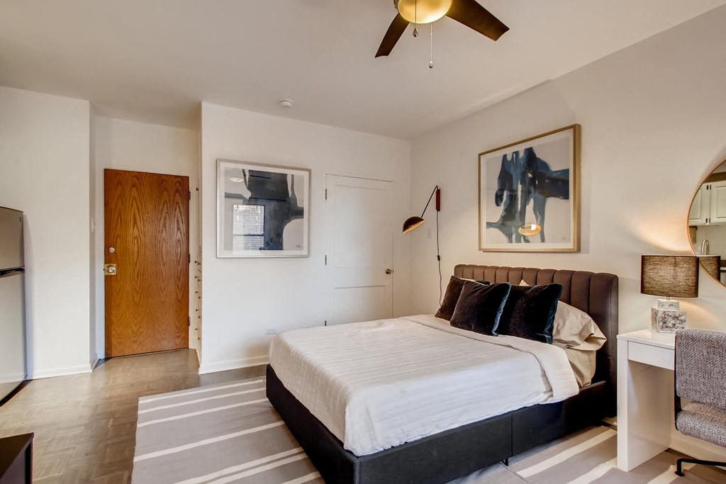 a bedroom with a bed and a ceiling fan