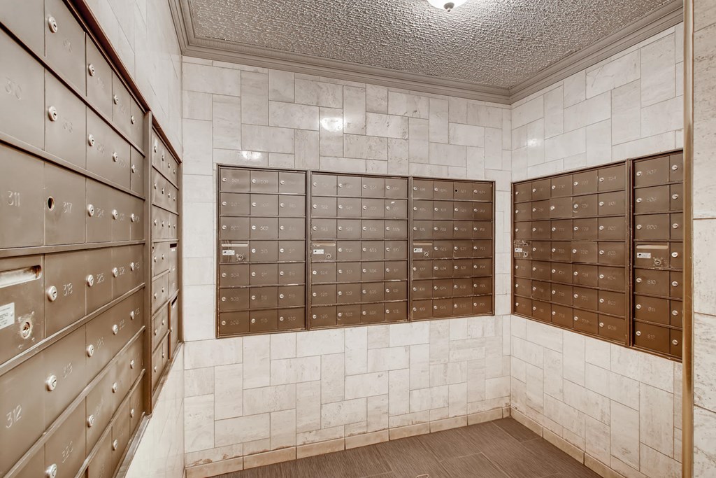 a locker room with wooden lockers and white tiled walls