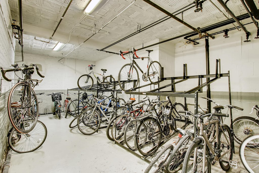 a large group of bikes parked in a garage