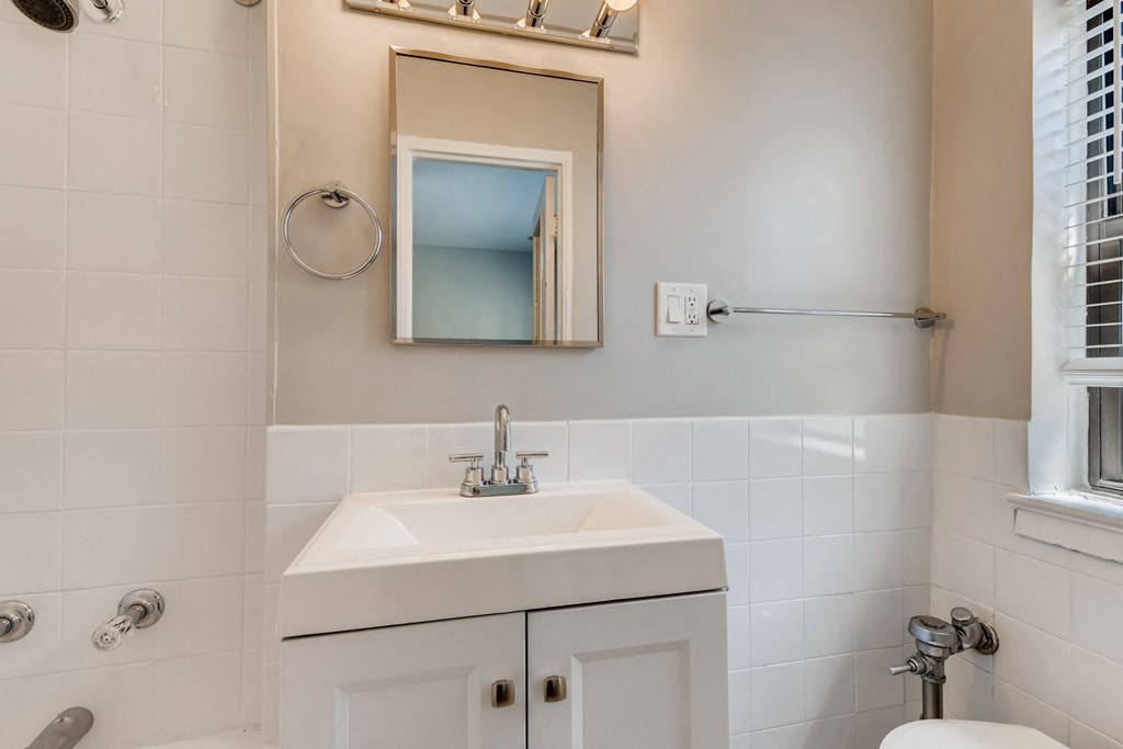 a bathroom with a sink and a mirror and a toilet