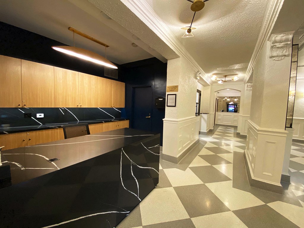 the lobby of a building with a checkered floor and a black and white