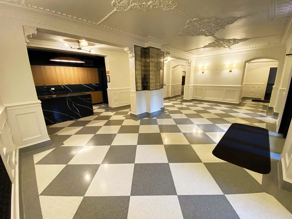 the lobby of a building with a checkered floor