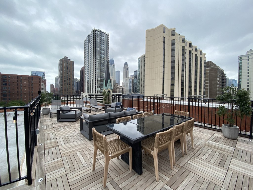 a roof deck with a view of the city