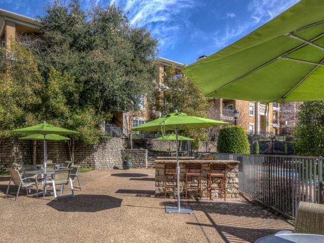 Outdoor grills with seating and umbrellas