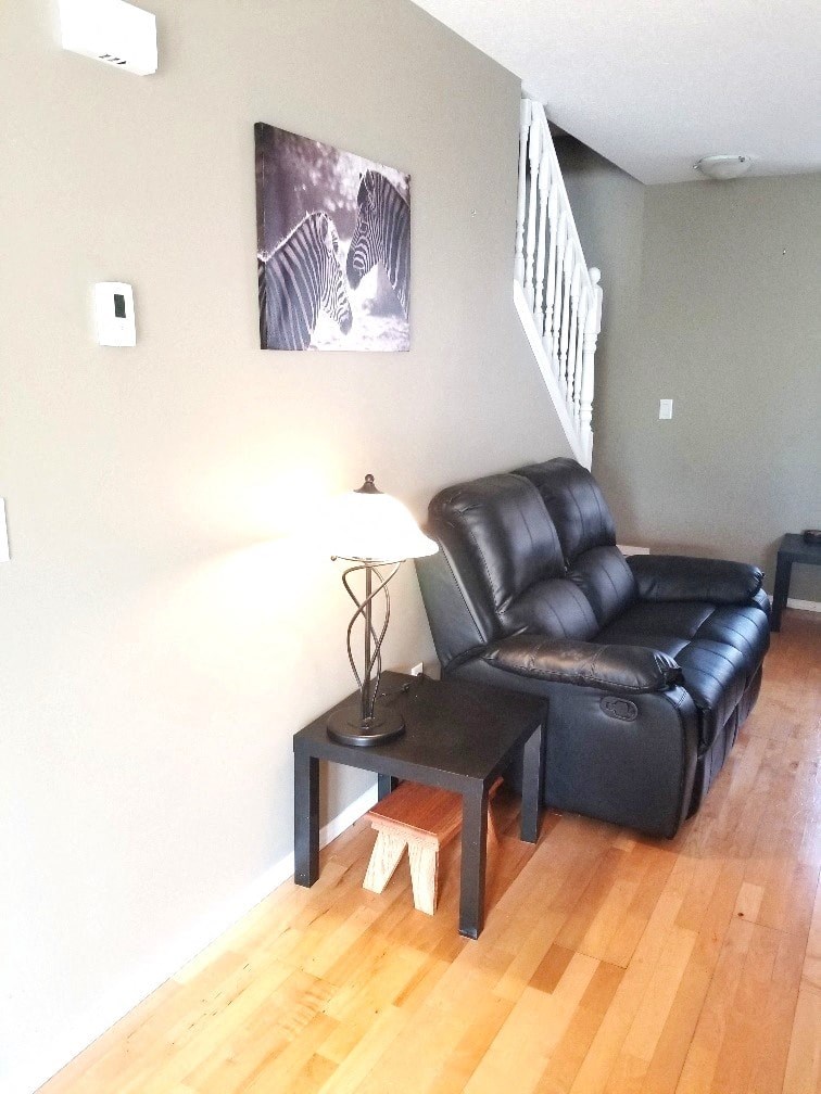 a living room with a leather couch and a table