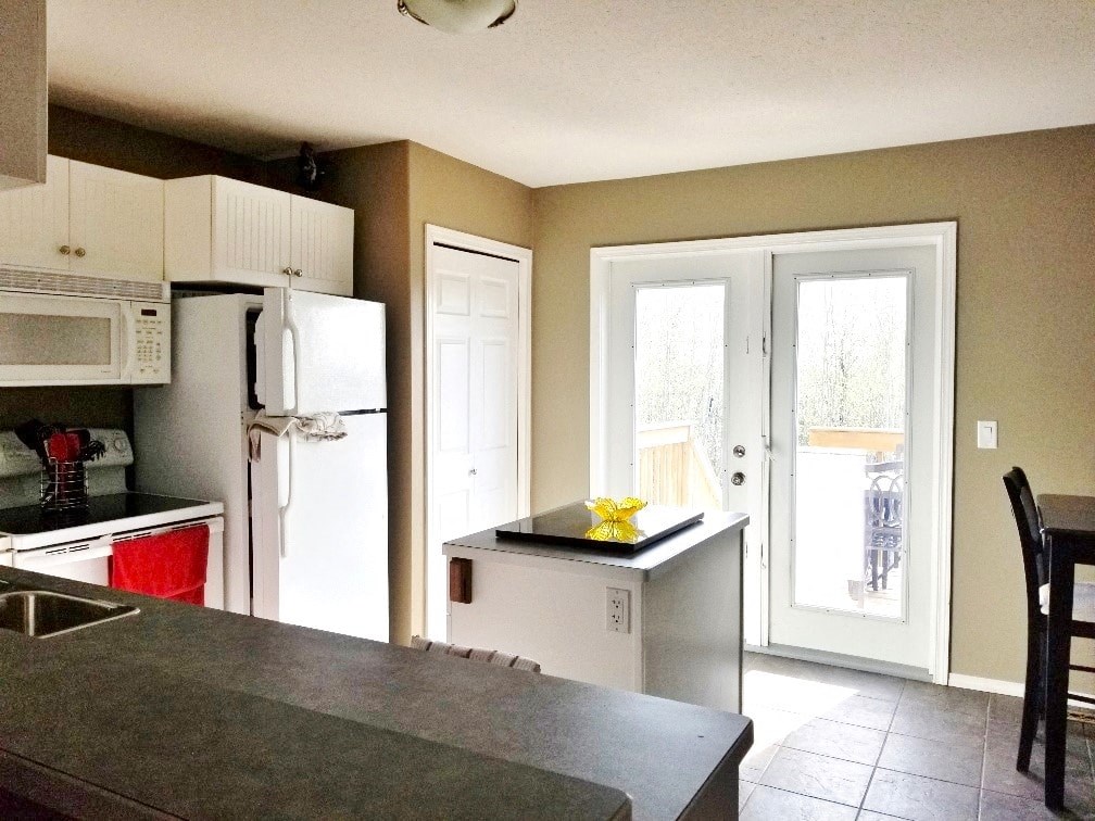 a kitchen with a counter top and a refrigerator