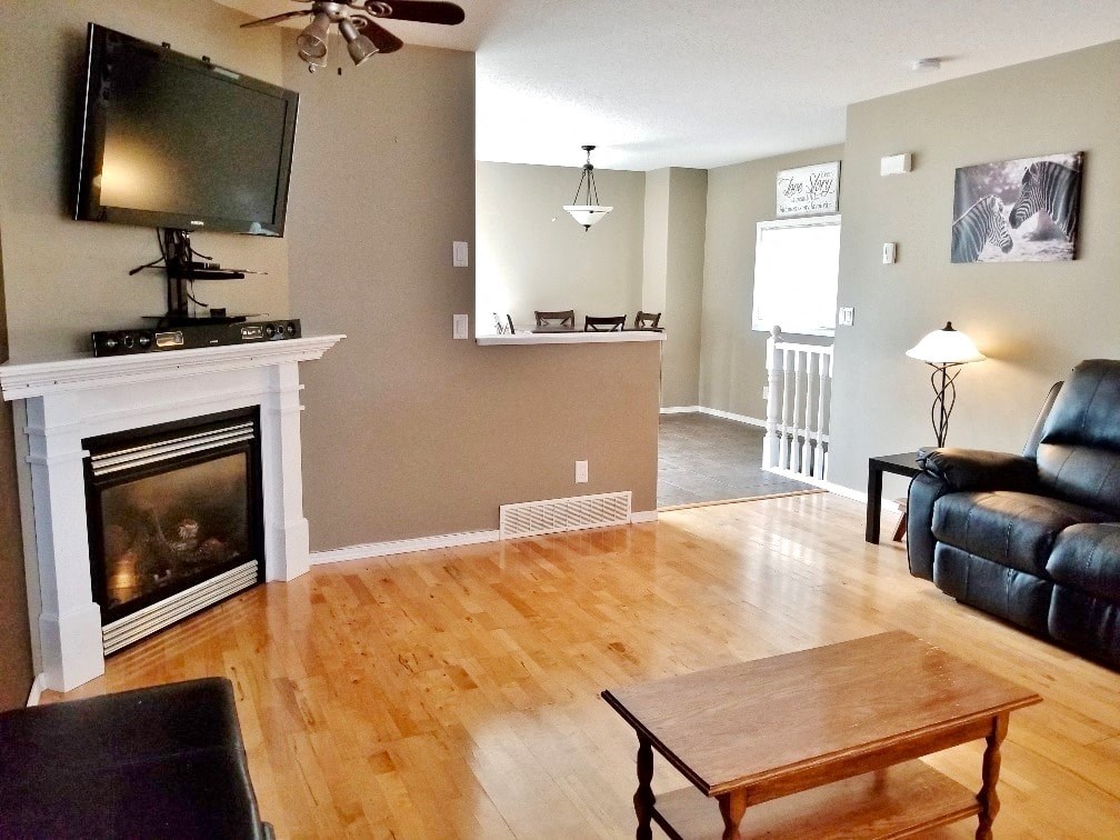 a living room with a fireplace and a coffee table