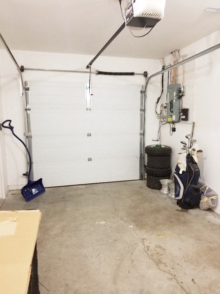 the garage door is closed and the floor is clean and ready to be remodeled