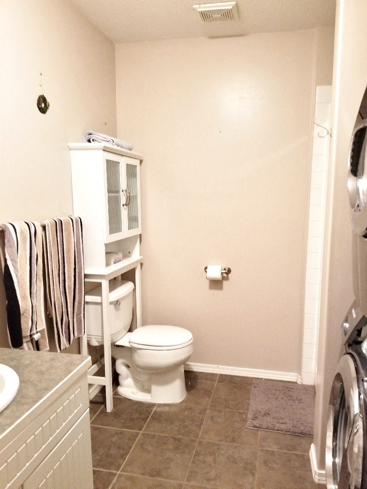a small bathroom with a toilet and a cabinet