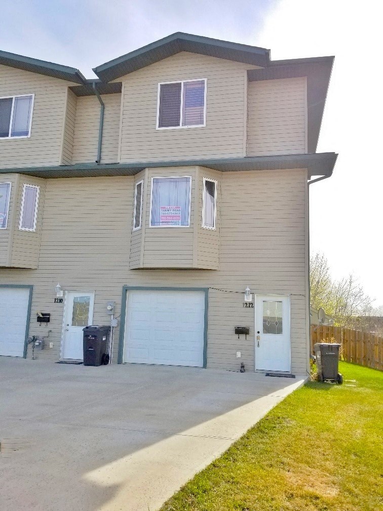 a house with two garage doors and a driveway