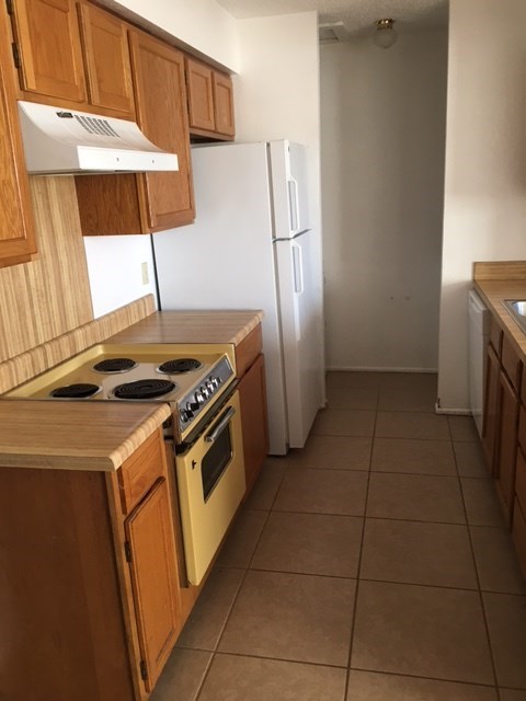 a kitchen with a stove and a refrigerator