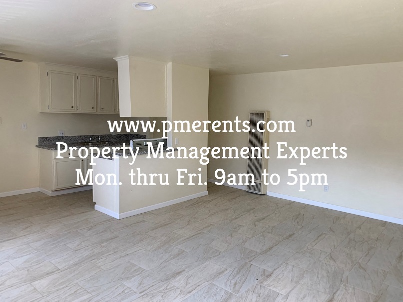 a hypothetical living room and kitchen in an empty house