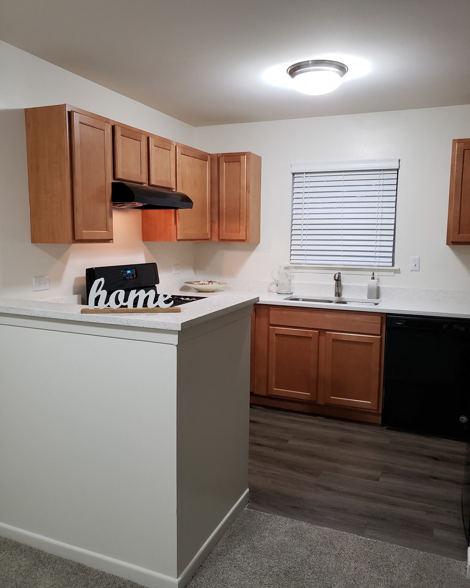 an empty kitchen with wooden cabinets and a counter top