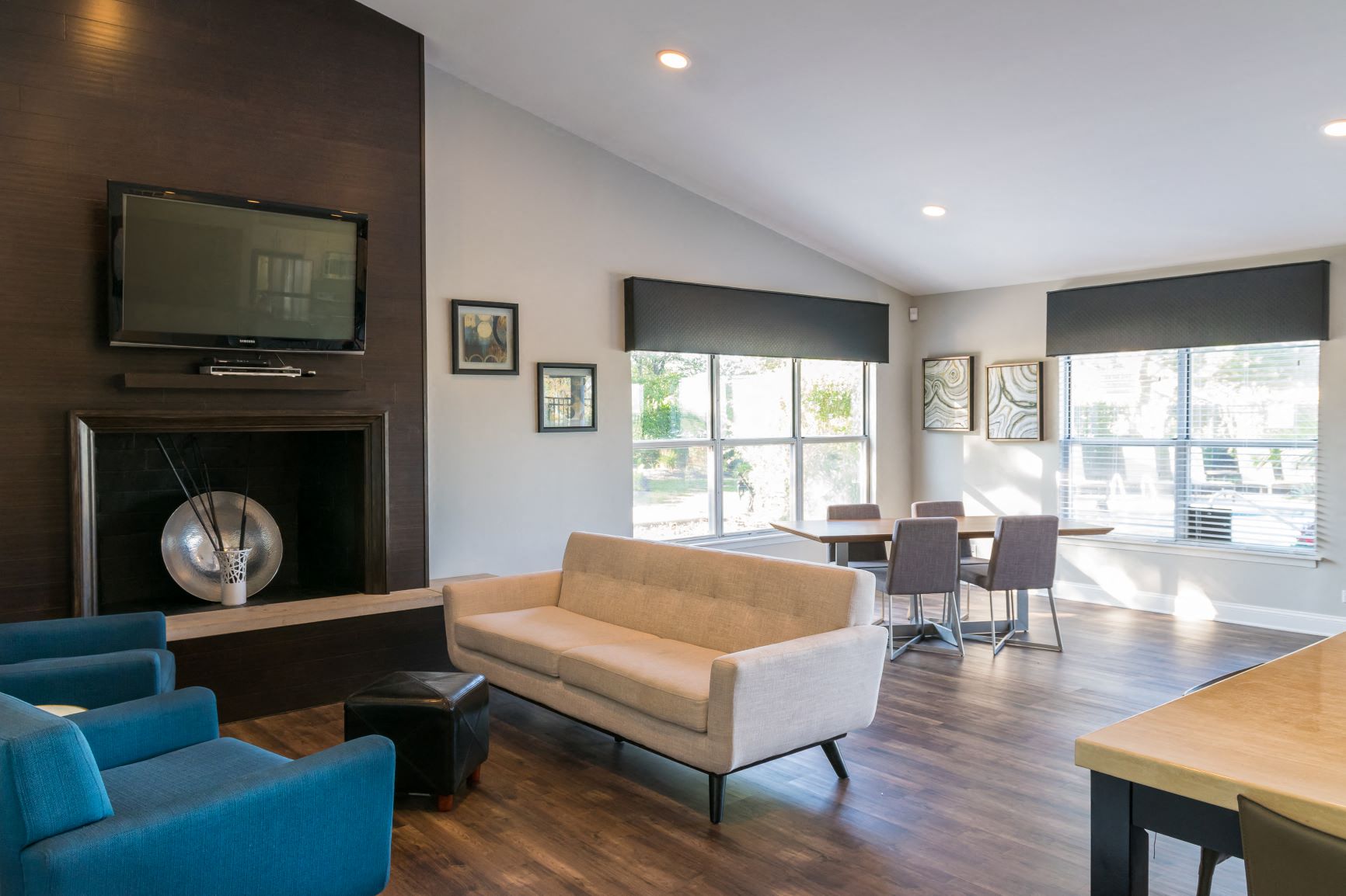 a living room with a couch and a table with chairs and a fireplace