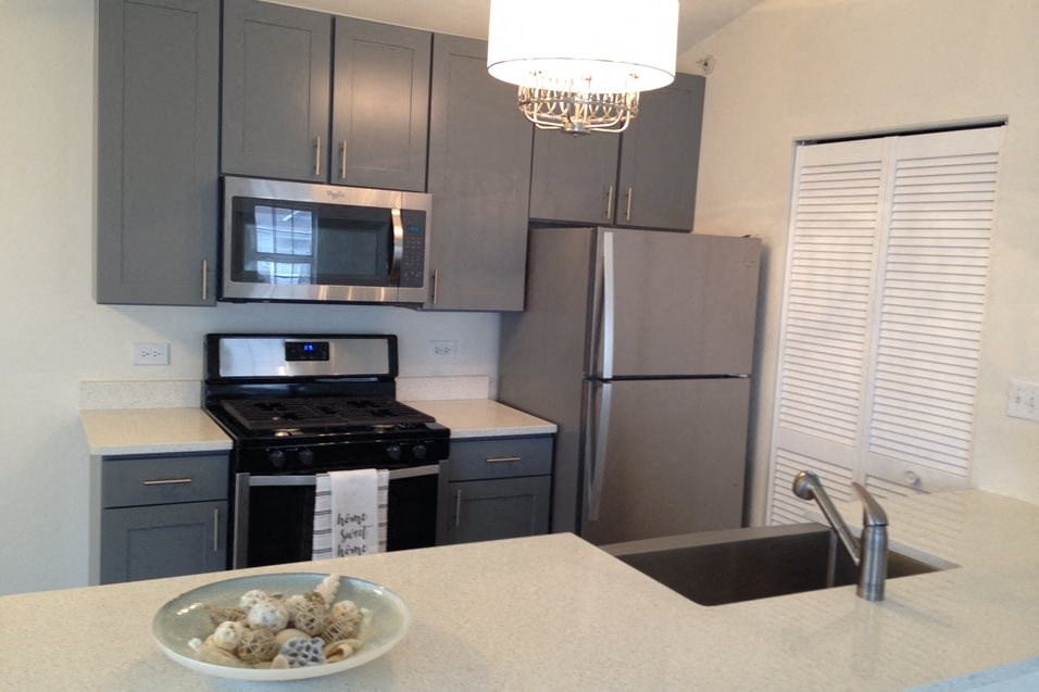 a kitchen with stainless steel appliances and a bowl of rocks