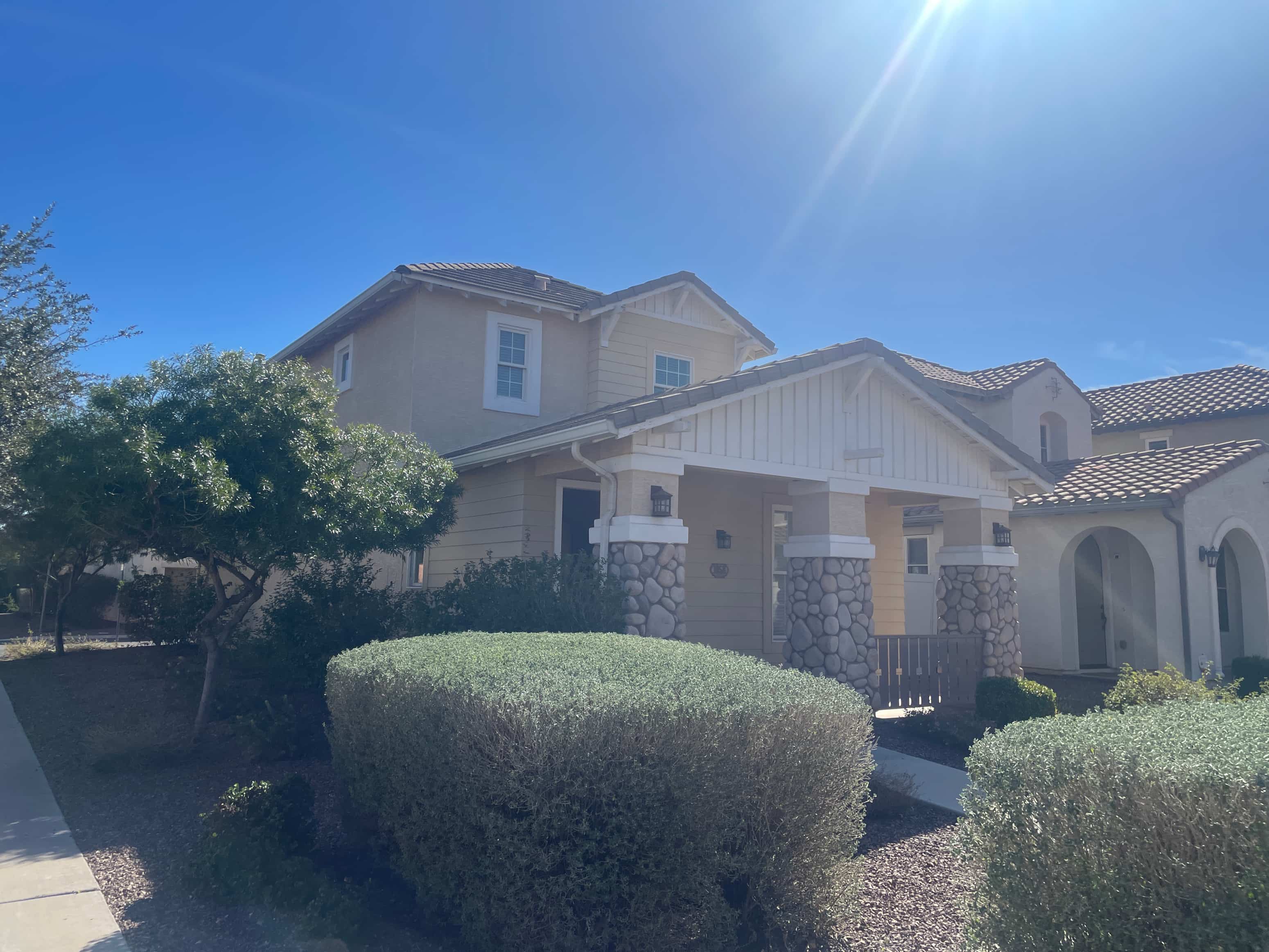 a house with the sun shining in front of it