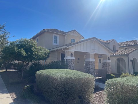 a house with the sun shining in front of it