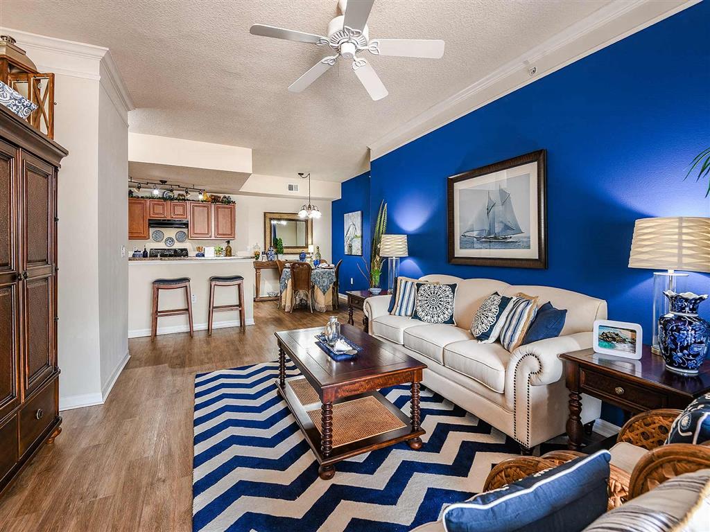 a living room and kitchen with a couch and a table