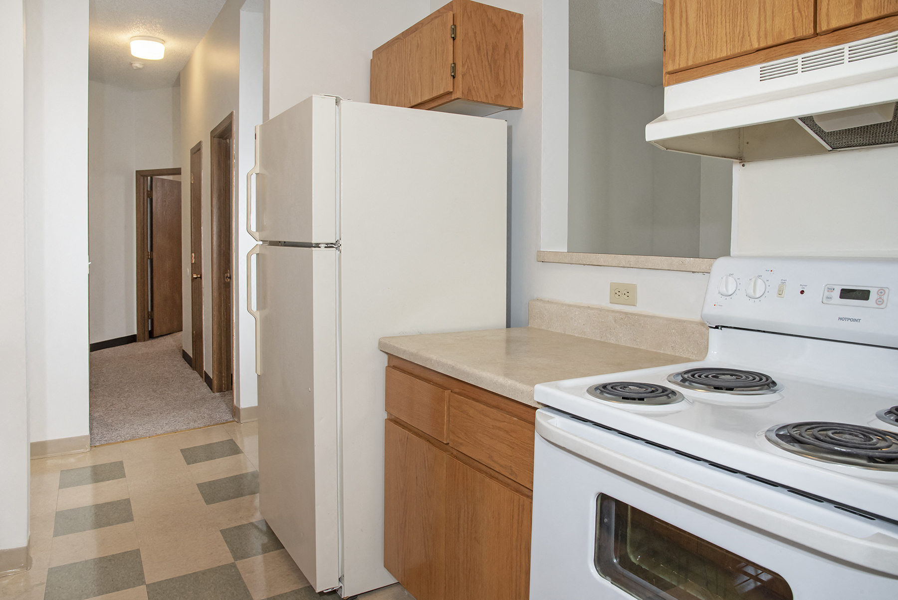 a kitchen with white appliances and a refrigerator and a stove