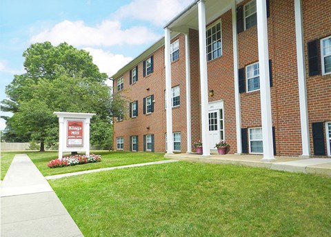 a large brick building with a sign in front of it